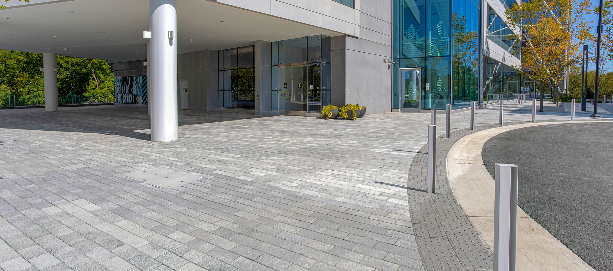 The entryway of Crescent Merriweather features two tones of rectangle pavers, matching the colors of the building.